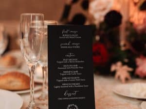 Black cardstock menu with white text